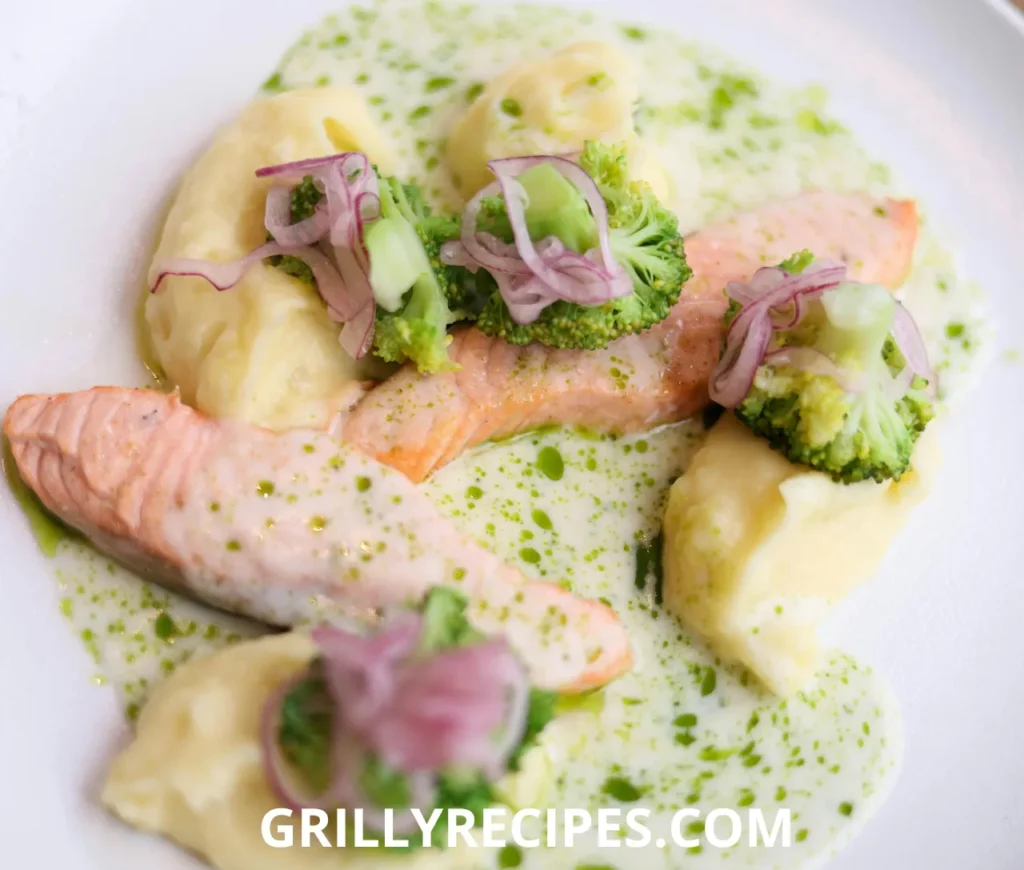 Chilled gefilte fish patties made with whitefish and carp, topped with carrot slices and fresh parsley, served with horseradish on a white plate, showcasing a traditional gefilte fish recipe.