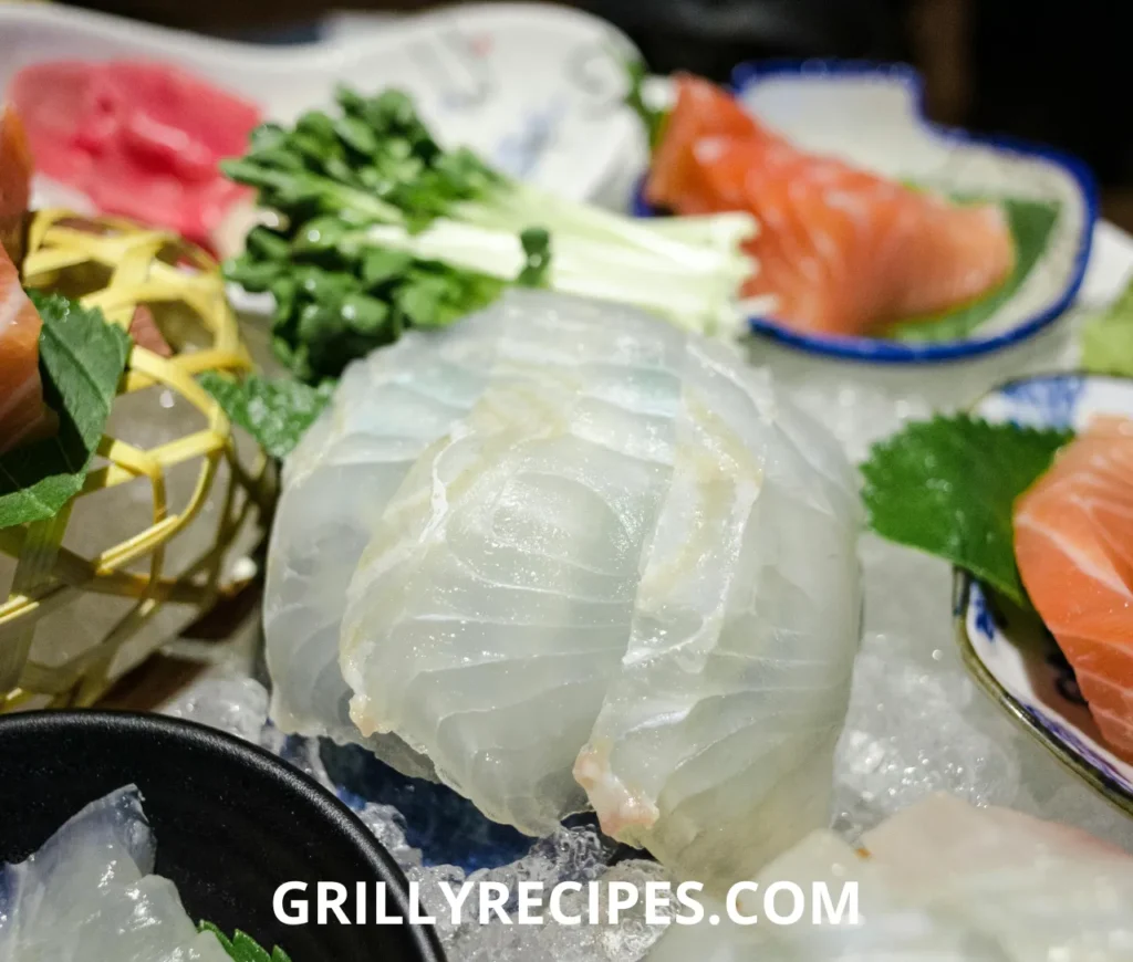 Silky cold smoked salmon layered over mixed greens, topped with cream cheese dollops, capers, red onion, and fresh dill on a white plate, showcasing an elegant cold smoked salmon recipe.