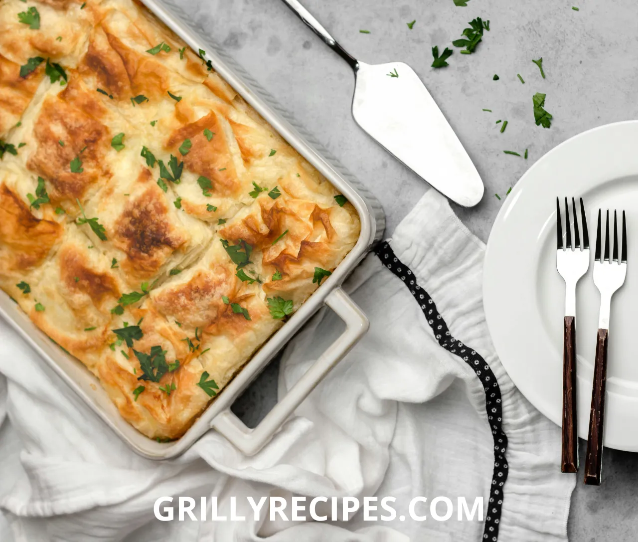 Homemade chicken pot pie with golden flaky crust and creamy filling on a wooden table